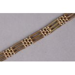 A 9ct. gold gate-link flexible bracelet. (12.9gm; with faults; one bar-link missing.