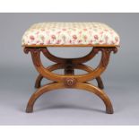 An early 19th century mahogany stool with padded rectangular seat upholstered cream leaf &