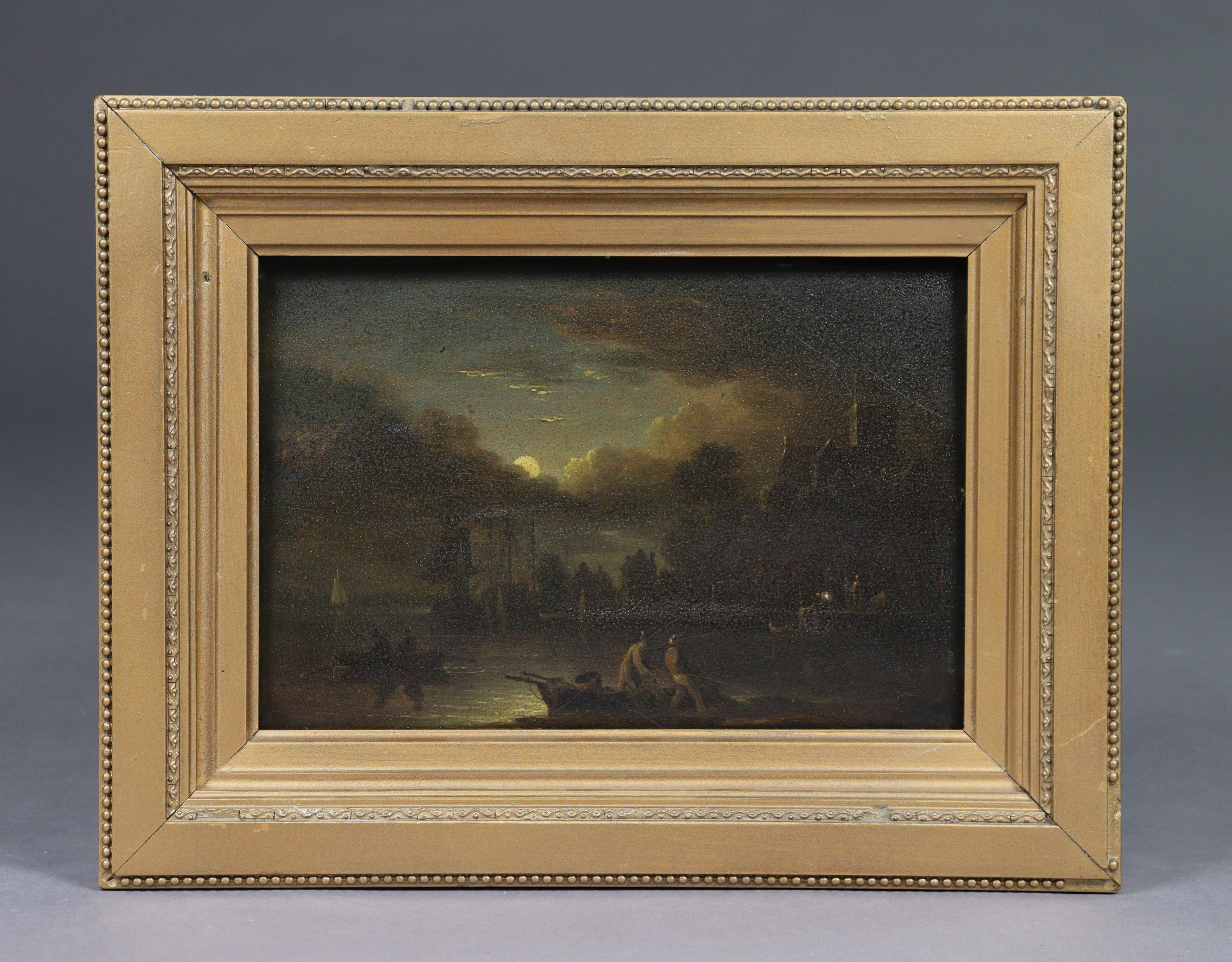 ENGLISH SCHOOL, late 18th century/early 19th century. A moonlit harbour scene with figures unloading