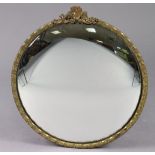 An early 20th century circular convex wall mirror in brass foliate frame, 15¾”x14½”.