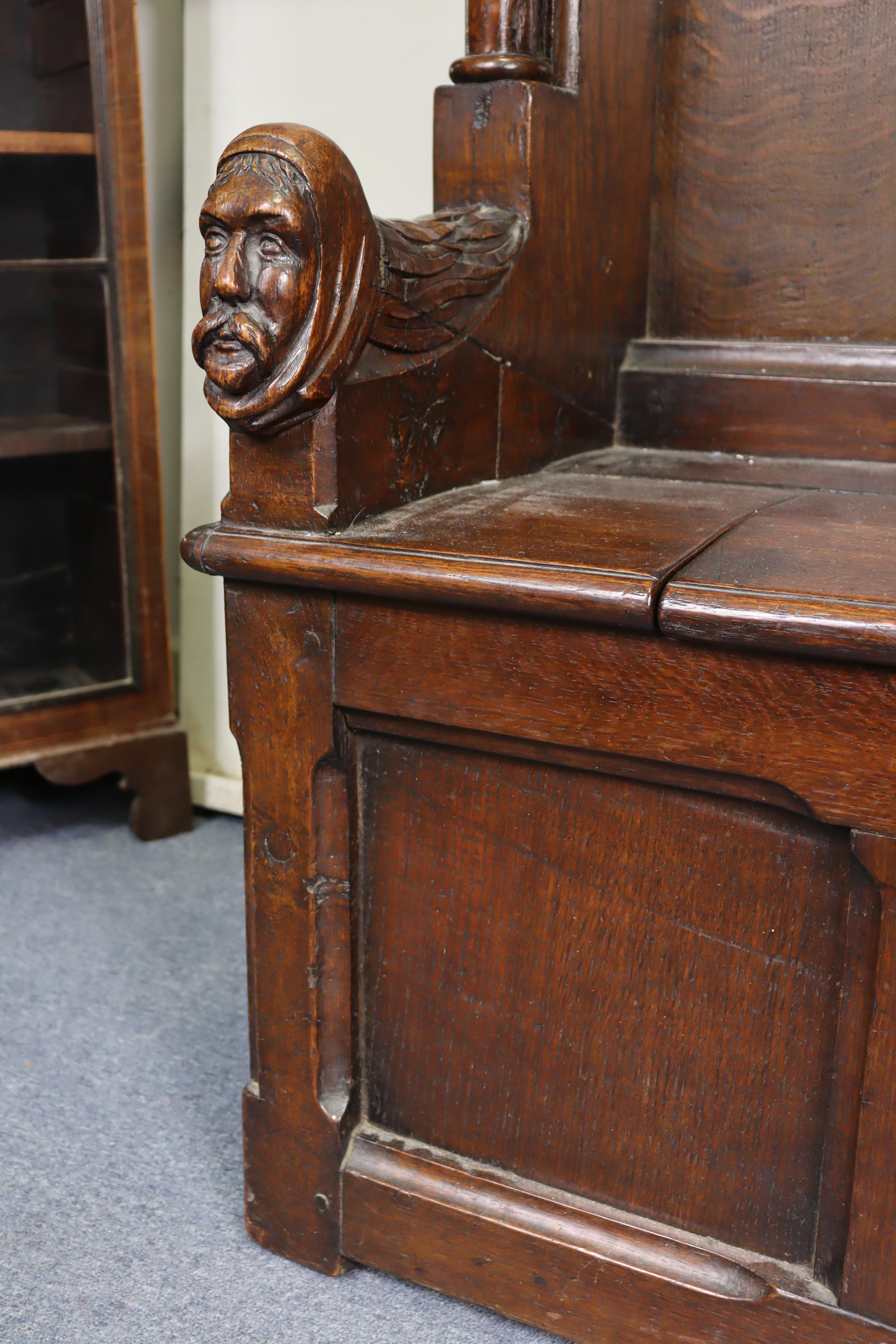 A late Victorian oak box-seat settle in the Gothic manner, the castellated panelled back flanked - Image 3 of 11