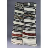 A pair of African tribal cloths, each of cream ground with repeating striped design, each 8’6”