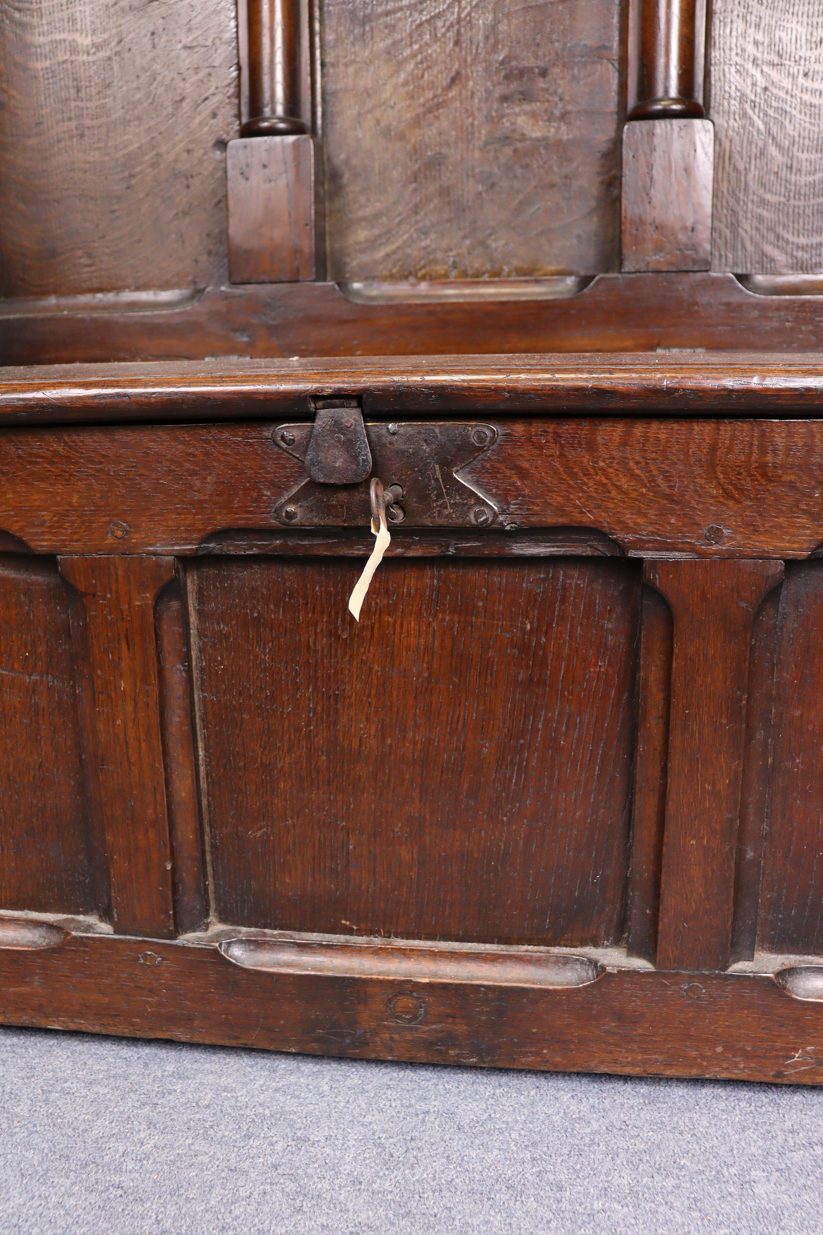 A late Victorian oak box-seat settle in the Gothic manner, the castellated panelled back flanked - Image 8 of 11