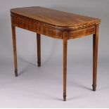 A Georgian inlaid mahogany tea table with rounded corners to the rectangular fold-over top, on