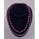 A necklace of opaque sapphire spherical beads, 22½” long; & another of facetted ruby beads, 20”