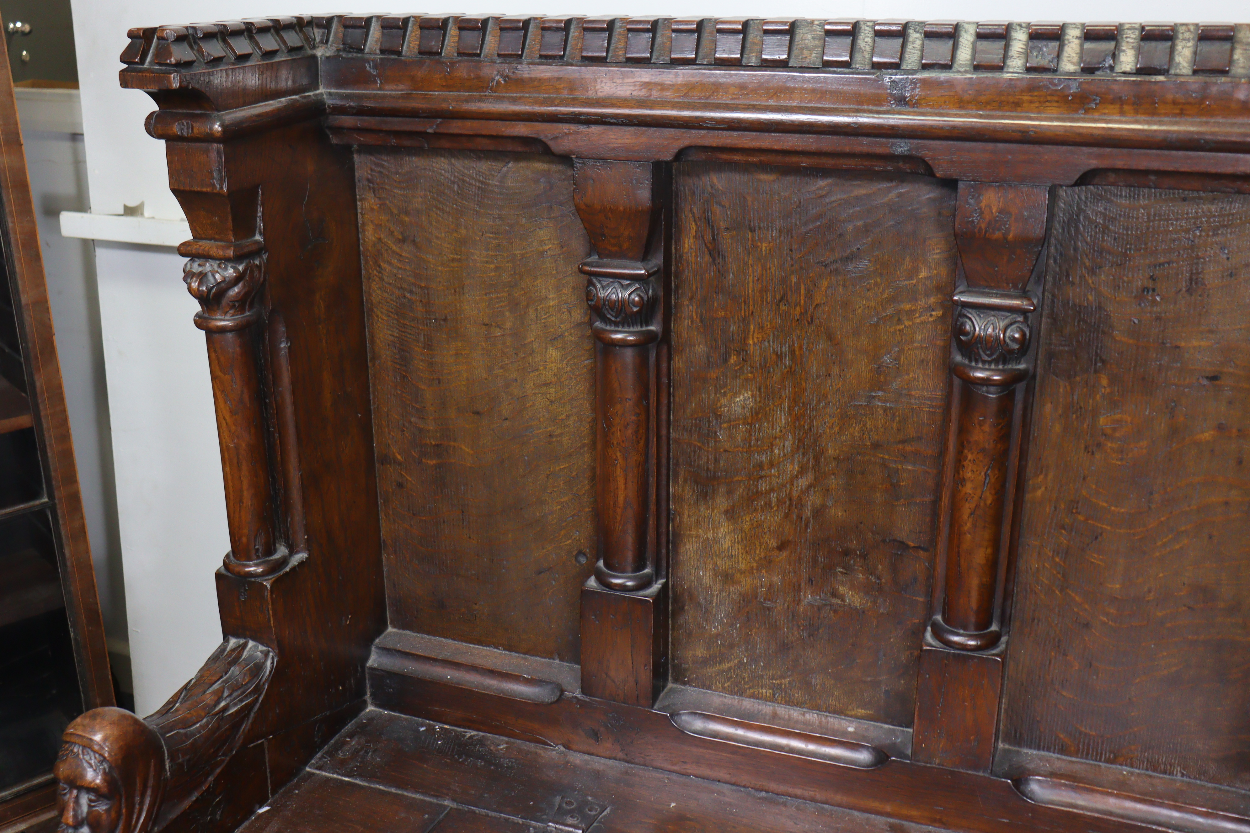 A late Victorian oak box-seat settle in the Gothic manner, the castellated panelled back flanked - Image 5 of 11