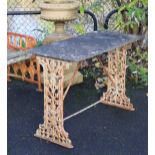 A 19th century cast iron garden table, the pierced ends of foliate design with rectangular stone