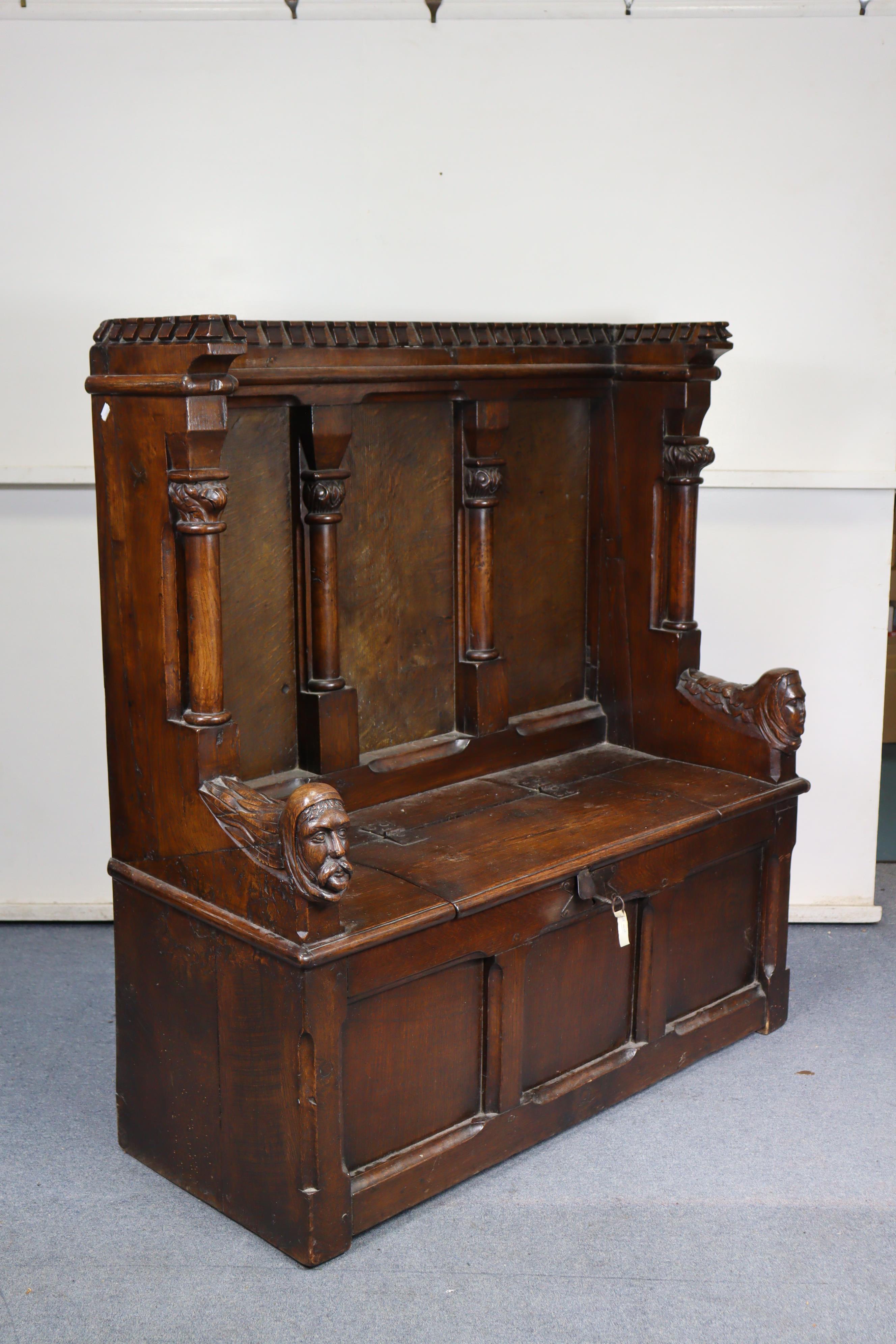 A late Victorian oak box-seat settle in the Gothic manner, the castellated panelled back flanked - Image 2 of 11