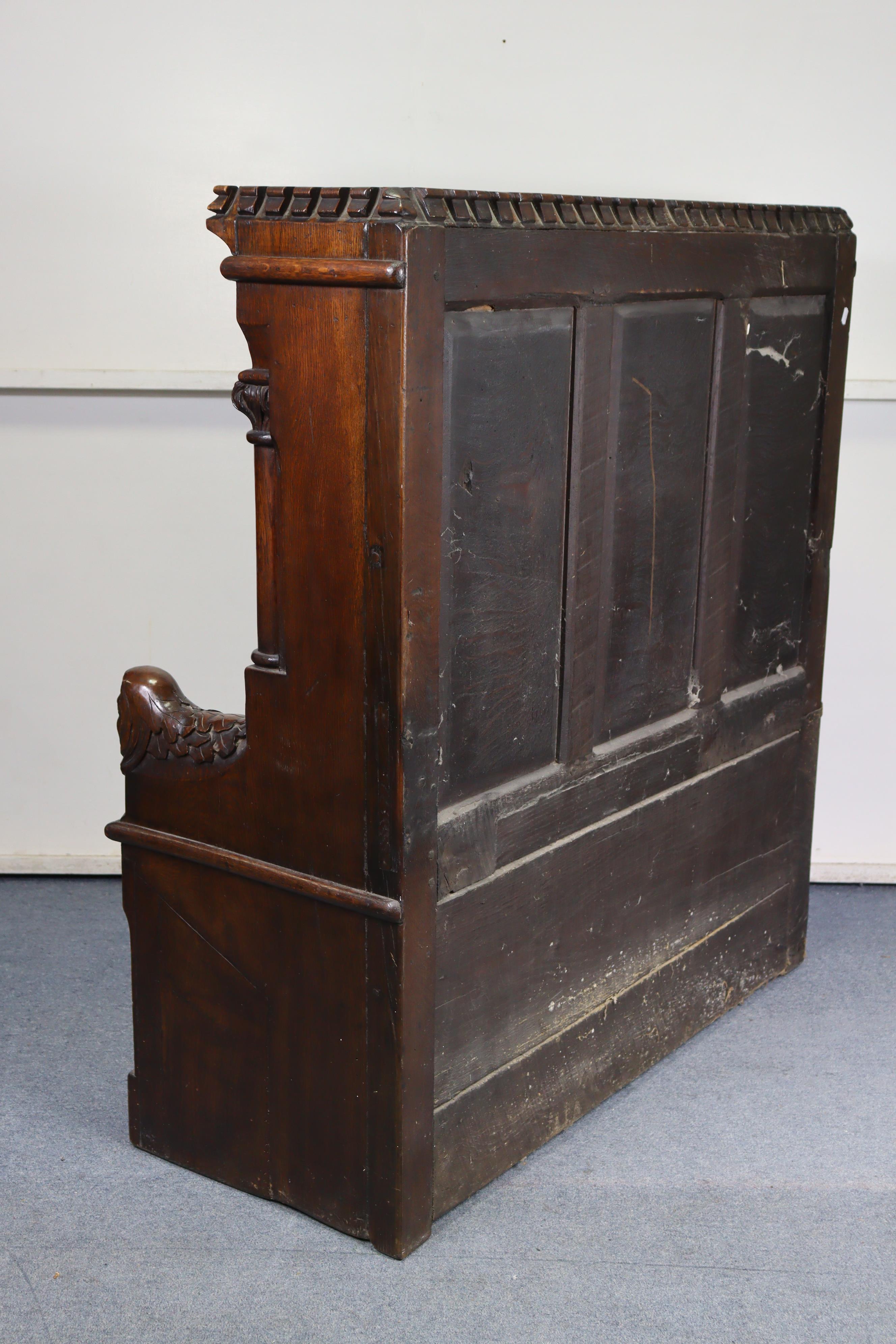 A late Victorian oak box-seat settle in the Gothic manner, the castellated panelled back flanked - Image 10 of 11