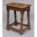 A 17th century oak joint stool with moulded edge to the hard seat, on ring-turned supports with