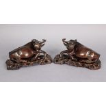 *WITHDRAWN* A pair of late 19th century Chinese carved hardwood models of recumbent ox, each on