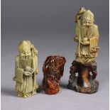 Two Chinese carved soapstone figures, one on hardwood stand, 4.75" & 7.25" high, & a carved amber fi