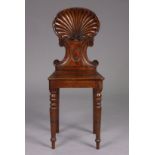 A Victorian mahogany hall chair with shell-shaped carved back, hard seat (reduced in depth) & on