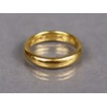 A 22ct. gold plain wedding band, Birmingham hallmarks for 1930; size: P, weight 8.3 gm.