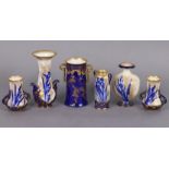 Five various Royal Doulton/Burslem small vases decorated in blue with Irises on a sprayed gilt