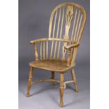 A 19th century ash & elm Windsor elbow chair with pierced & shaped splat to the hooped spindle back,