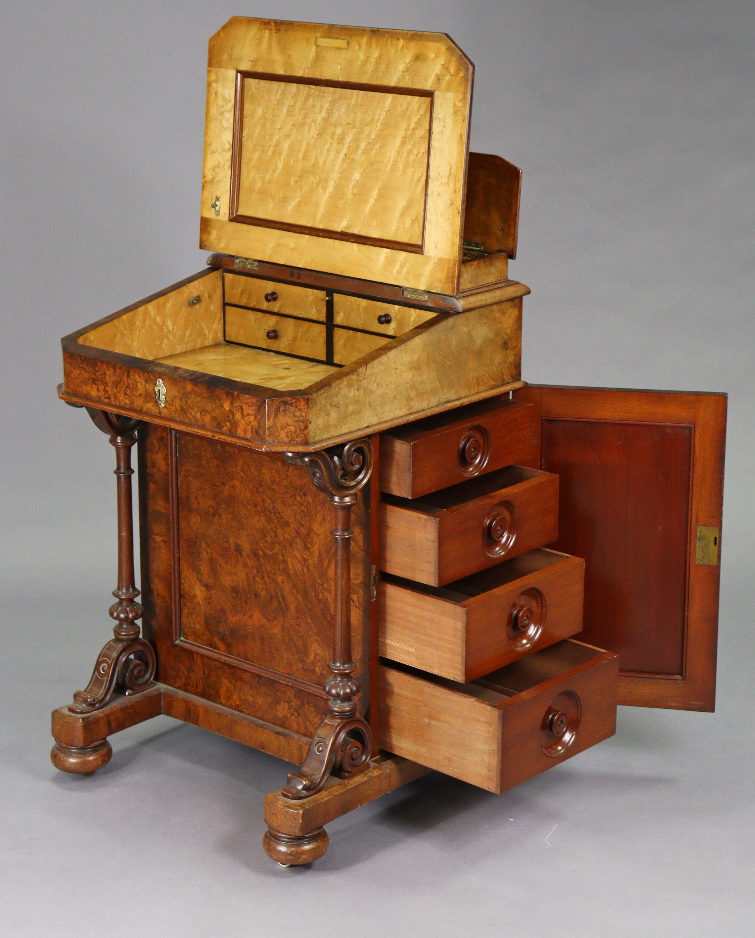 A Victorian burr-walnut davenport with satinwood interior enclosed by sloping hinged lid, inset