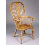 A 19th century ash & elm Windsor elbow chair with pierced & shaped splat to the hooped spindle back,