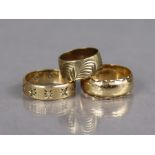 A 9ct. gold band with engraved band (size I); another (size R); & another set small white stones (