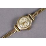 An Omer Incabloc 9ct. gold ladies’ wristwatch, the small silvered dial with gold baton numerals &