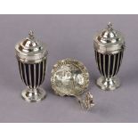 A pair of Edwardian silver vase-shaped wirework pepper pots with flame finials to the pull-off lids,