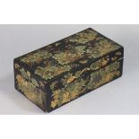 A Japanese lacquer rectangular box with all-over polychrome floral decoration on a black ground, the
