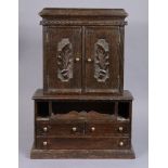 A Victorian oak ‘apprentice-piece’ miniature cabinet-on-chest, the upper part enclosed by pair