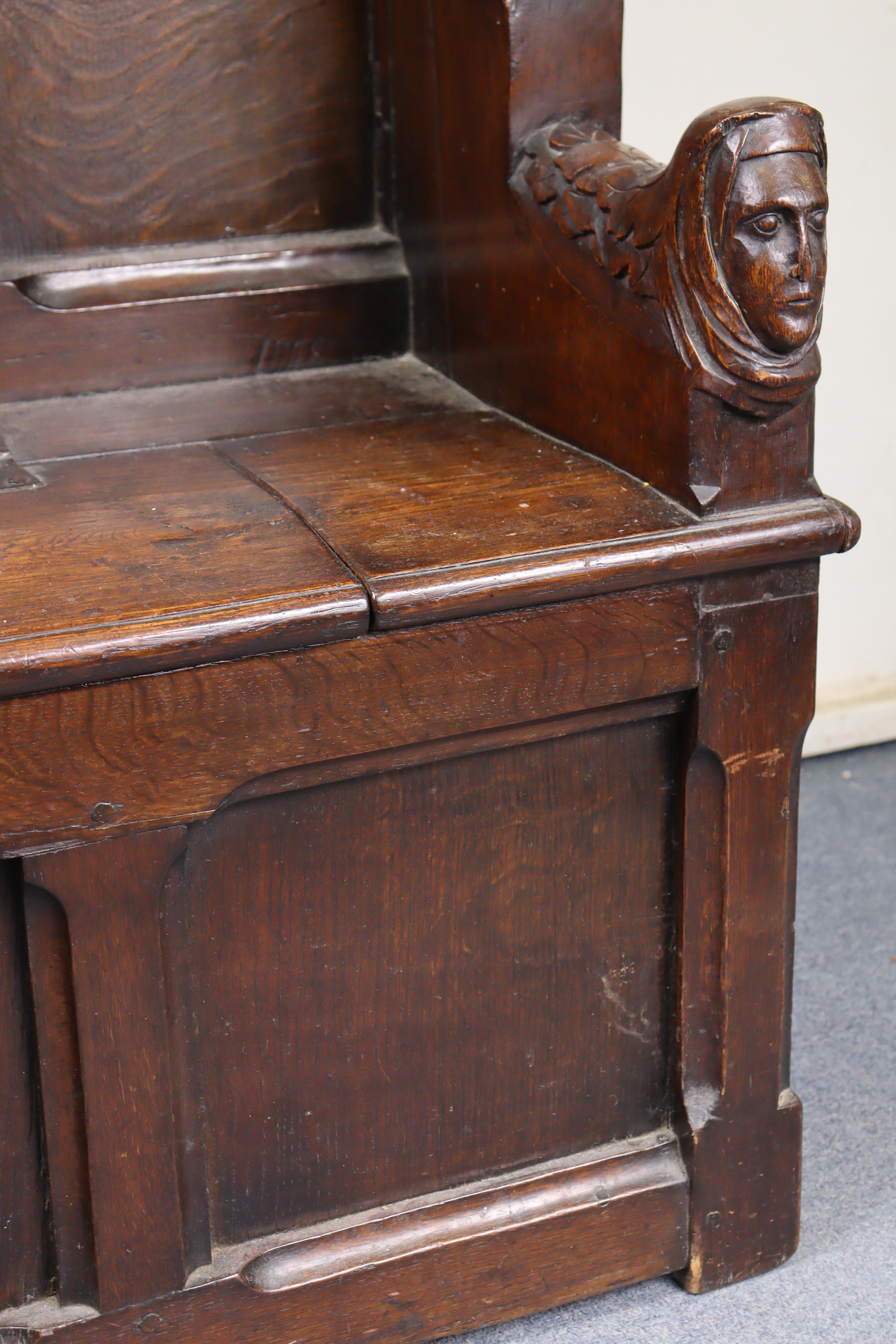 A late Victorian oak box-seat settle in the Gothic manner, the castellated panelled back flanked - Image 4 of 11