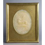 A 19th century wax relief oval plaque depicting Christ carrying the cross to one side, & paschal