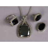 A hematite pendant set within a marcasite narrow border, on fine-link chain necklet; a ditto ring; &