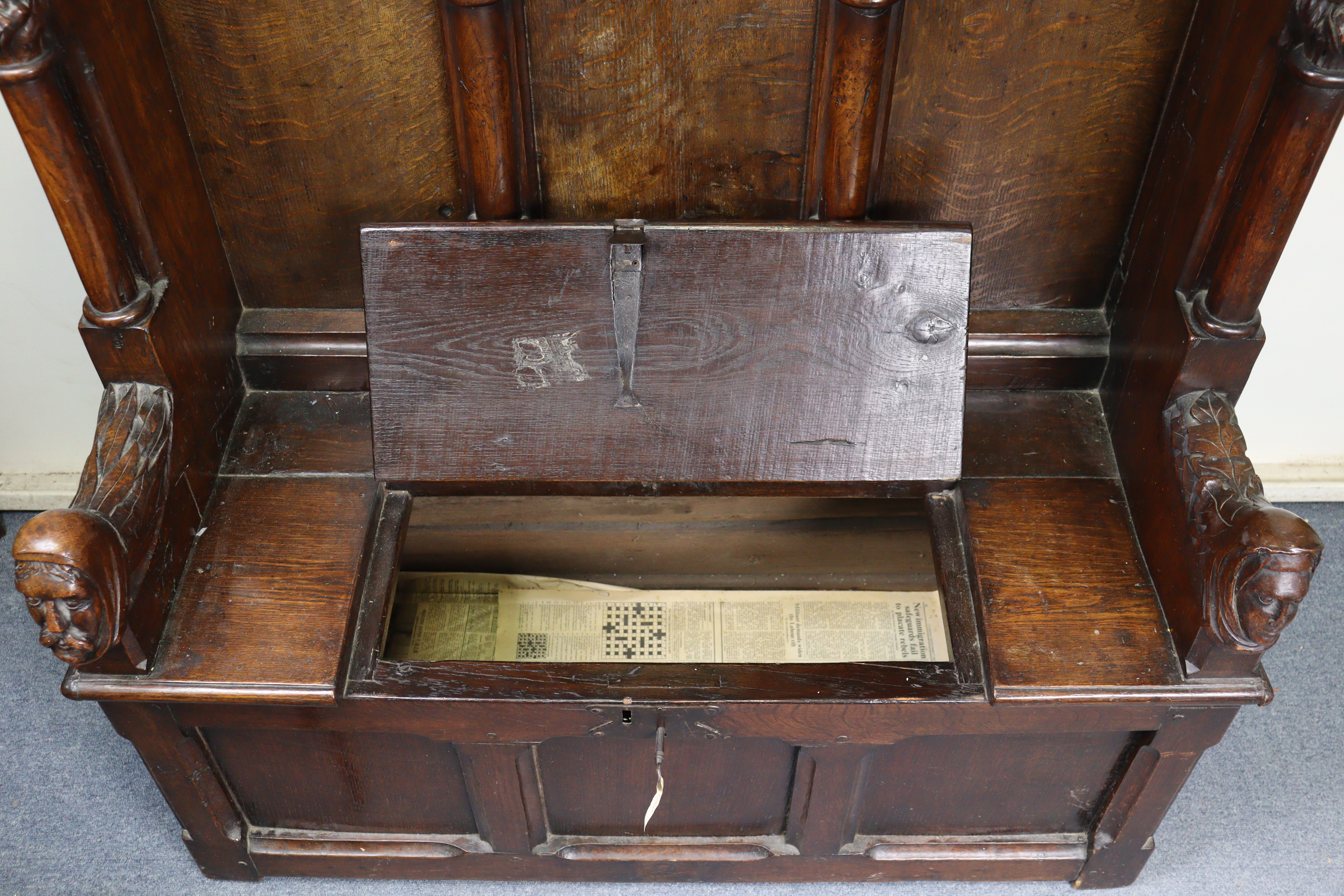 A late Victorian oak box-seat settle in the Gothic manner, the castellated panelled back flanked - Image 7 of 11