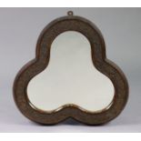 An early 20th century trefoil shaped wall mirror in carved leaf-carved wooden frame with painted