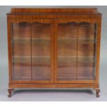 A late 19th/early 20th century mahogany display cabinet fitted two plate glass shelves enclosed by