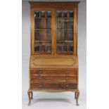 An Edwardian mahogany bureau bookcase fitted three adjustable shelves enclosed by pair of glazed