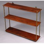 A Victorian mahogany three-tier open wall shelf on brass rope twist supports with flame finial