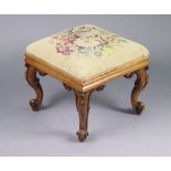 A Victorian grained-wood square stool on four carved cabriole legs with brass castors, & with a