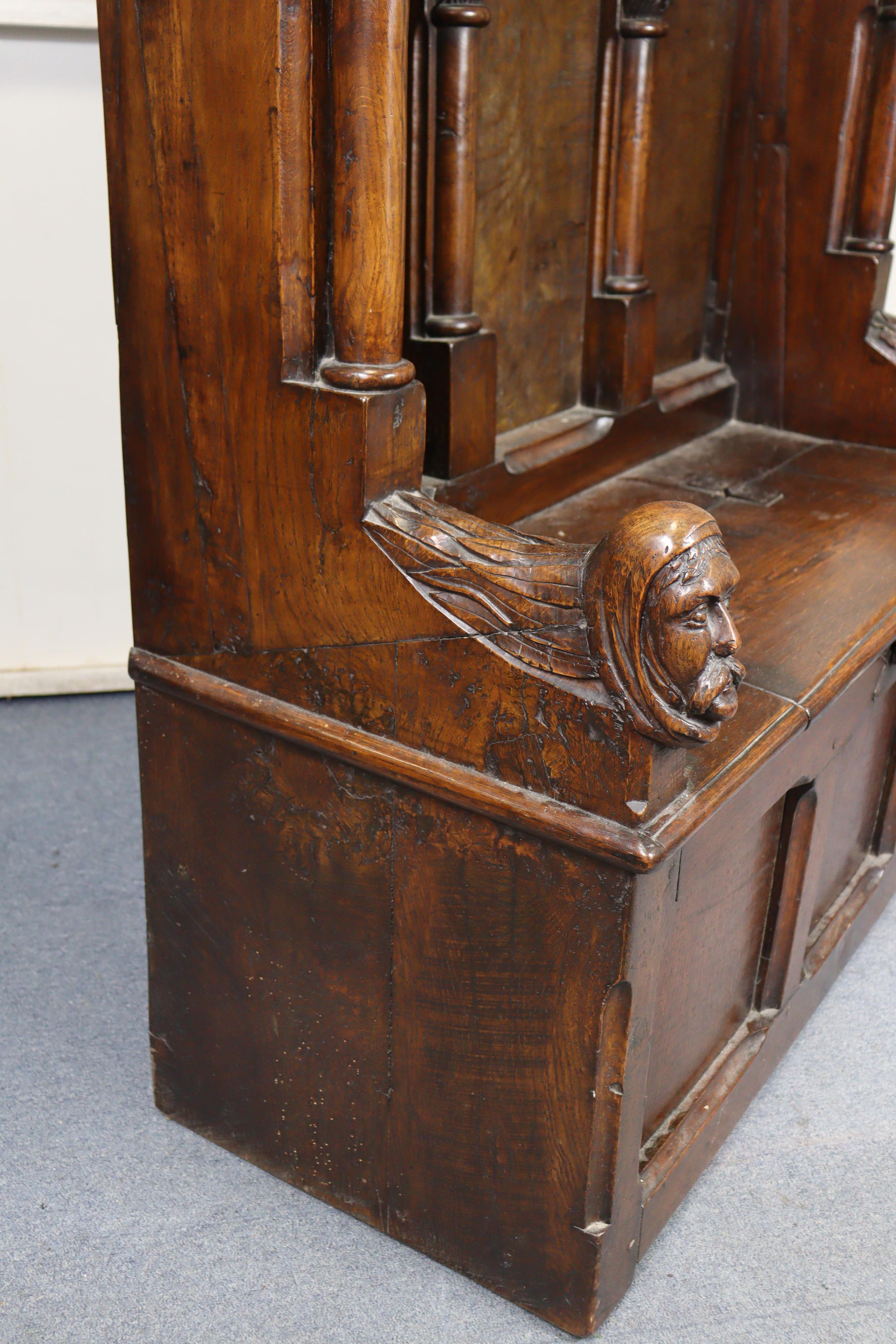 A late Victorian oak box-seat settle in the Gothic manner, the castellated panelled back flanked - Image 9 of 11