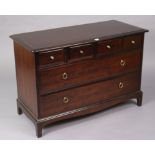 A Stag “minstrel” mahogany-finish dwarf chest fitted four short & two long drawers, & on a shaped