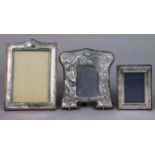 Three silver rectangular photograph frames.