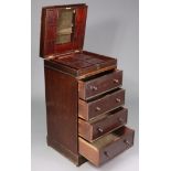 A late 19th/early 20th century mahogany upright sewing cabinet with a fitted interior enclosed by