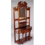 A Victorian-style carved mahogany tall hallstand inset rectangular bevelled plate to the top, with