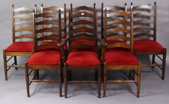 A set of eight ladder-back dining chairs (including one carver) with padded drop-in-seats, & on
