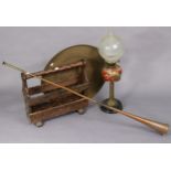 A brass oil table lamp with floral painted glass reservoir and with an etched glass globular