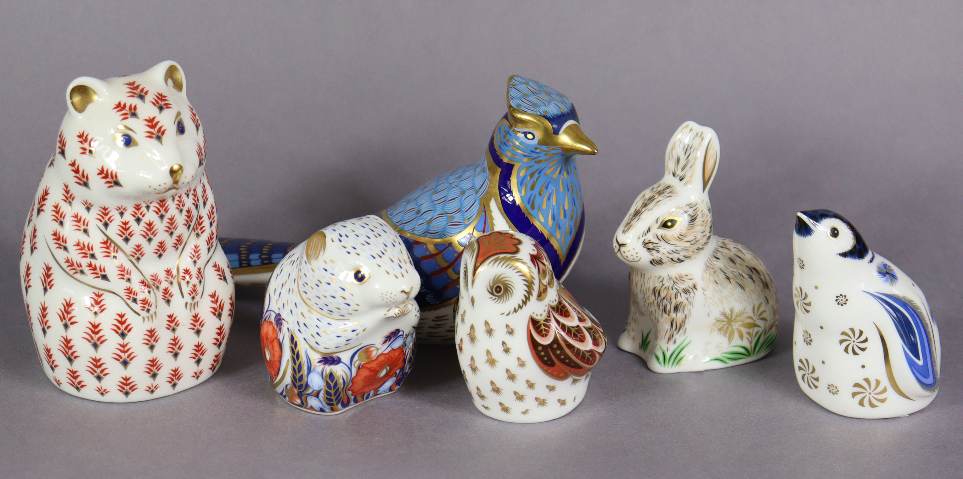 Six Royal Crown Derby porcelain paperweights: Hamster; Blue Jay; Snowflake (Penguin); Owlet; Nibbles