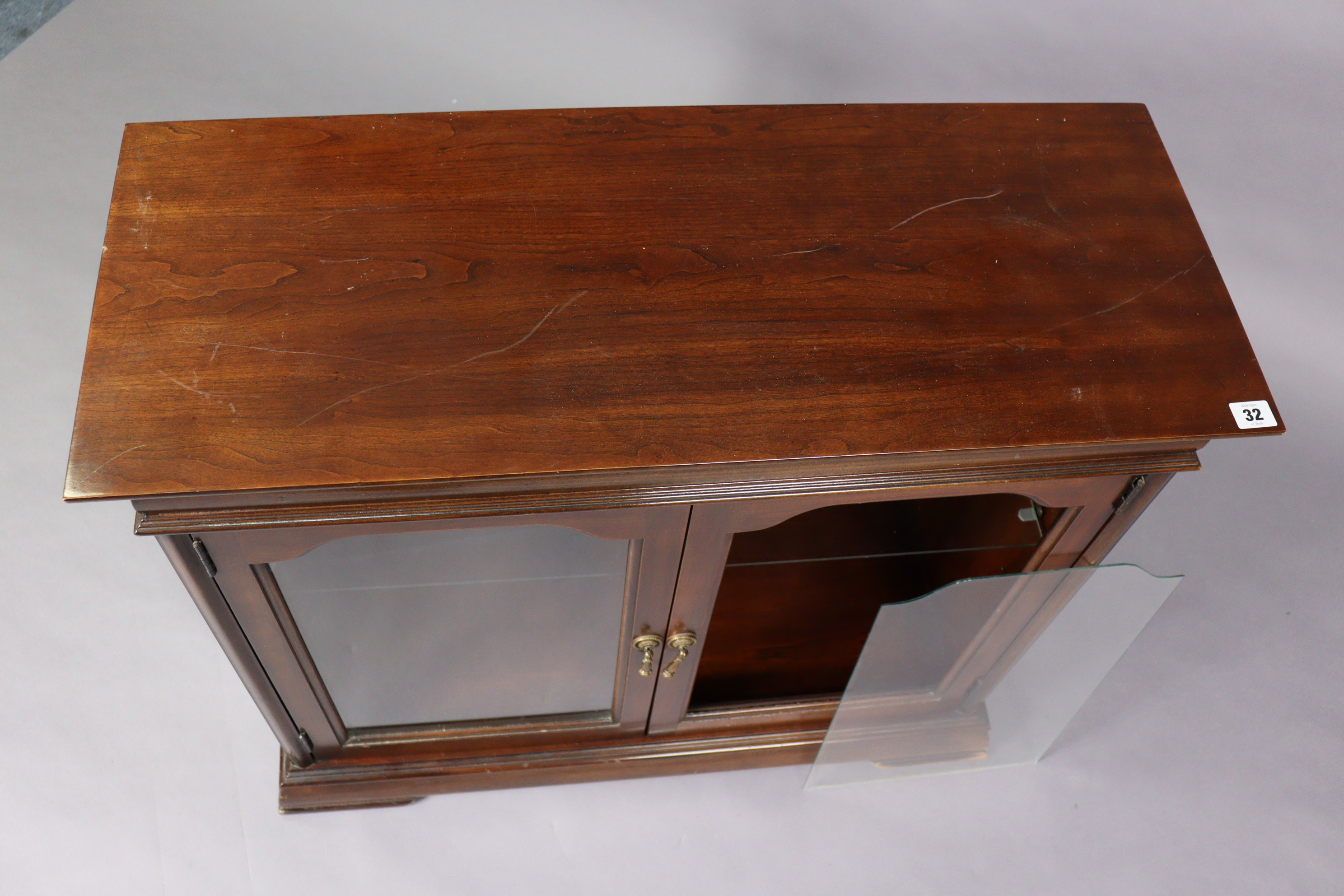 A mahogany dwarf cabinet fitted with a plate-glass shelf, & on a shaped plinth base, 33” wide x - Bild 2 aus 2