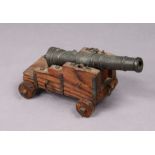A vintage cast-metal British naval signal cannon with raised anchor & royal R crest, & mounted on