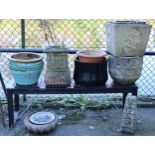 A teak slatted potting table on square legs, 53” wide x 17½” high; nine garden jardinières; & a