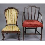 A 19th century carved hardwood nursing chair with a spoon-shaped back & padded seat, & on short