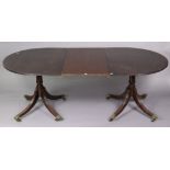 A 19th century mahogany twin-pedestal extending dining table with d-shaped tilt-top ends, having a