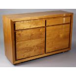 A teak sideboard fitted two frieze drawers above cupboard enclosed by a pair of panel doors, 55½”